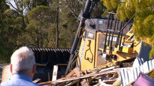 The alleged driver of the bulldozer is also accused of trying to run down a man on the property. (9NEWS)