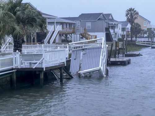 A dock is upended in a North Myrtle Beach, S.C., canal after Tropical Storm Idalia caused flooding throughout the area on Thursday, Aug. 31, 2023. 