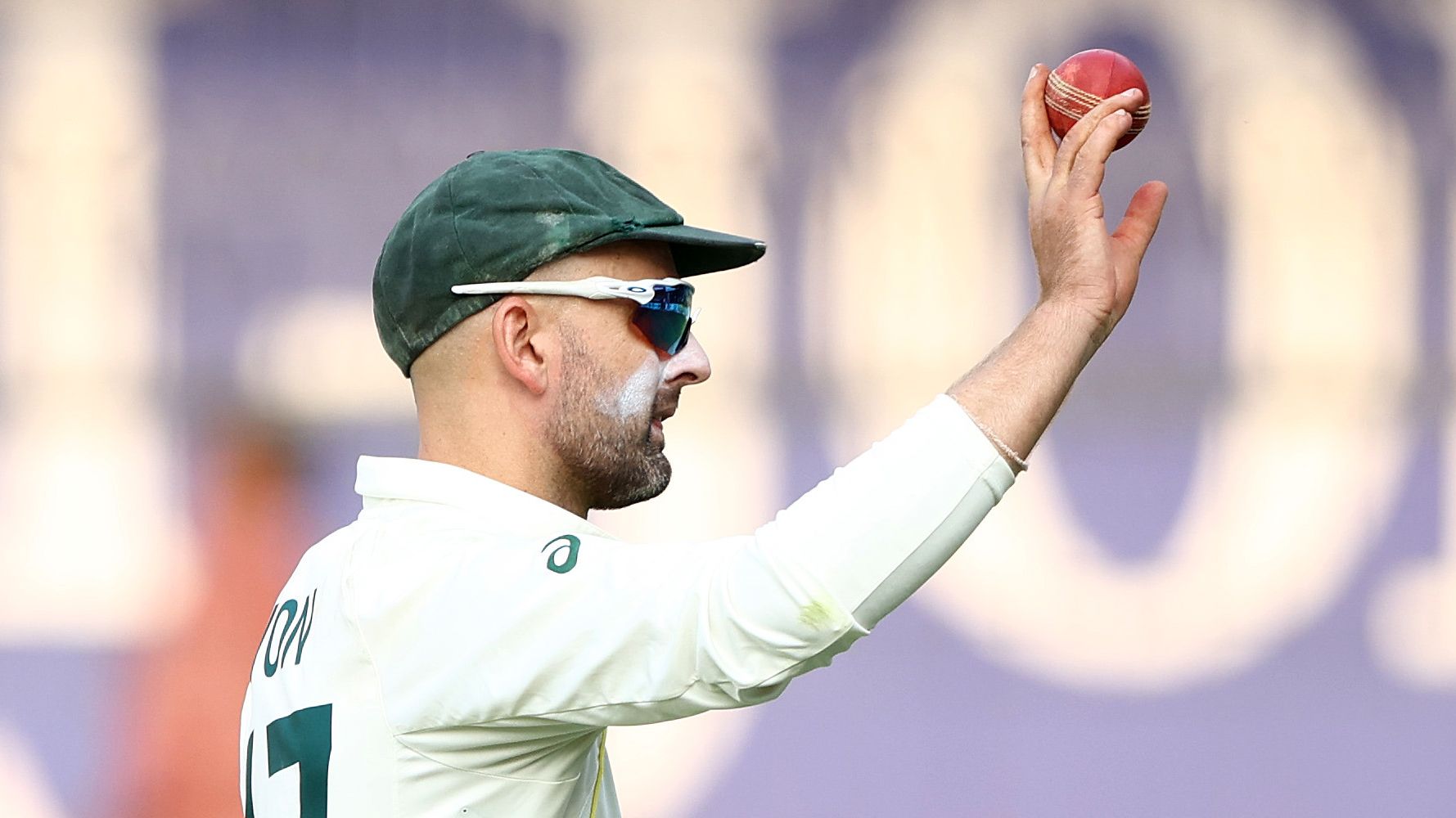 INDORE, INDIA - MARCH 02: Nathan Lyon of Australia holds up the ball after he took eight wickets in the second innings during day two of the Third Test match in the series between India and Australia at Holkare Cricket Stadium on March 02, 2023 in Indore, India. (Photo by Robert Cianflone/Getty Images)