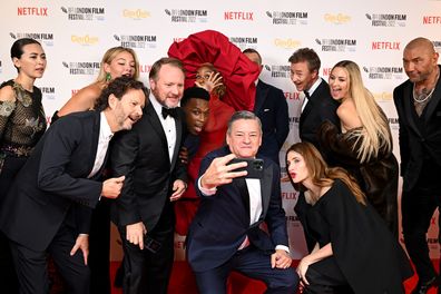 Jessica Henwick, Madelyn Cline, Leslie Odom Jr., Ram Bergman, Janelle Monáe, Daniel Craig, Rian Johnson, Edward Norton, Kate Hudson, Dave Bautista and Kathryn Hahn take a group selfie during the "Glass Onion: A Knives Out Mystery" European Premiere and Closing Night Gala during the 66th BFI London Film Festival at The Royal Festival Hall on October 16, 2022 in London, England. 