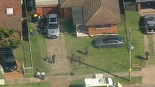 Three people have been arrested in Sydney's west over a body found in a burnt-out tent in Geelong.