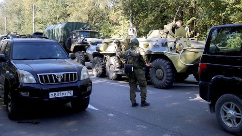 An army tank is seen at the scene of an attack on a school in Kerch in Crimea, Russia.