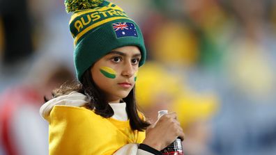 A young Matildas supporter welcomes her team to the field.