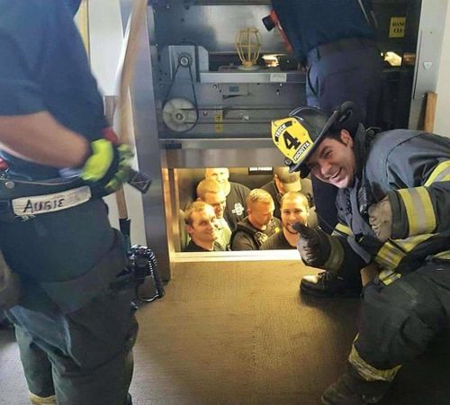 US firefighter snapped giving the thumbs up while rescuing cops trapped in elevator