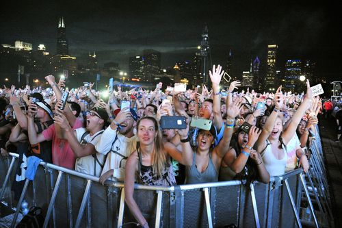 In this photograph from August 5, concertgoers attend day three of Lollapalooza in Grant Park on in Chicago. (AAP)