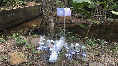 Flowers are placed at the scene where a woman was found dead a day earlier at a secluded spot on the southern island of Phuket, Thailand.