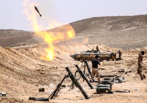 March 2016. Soldiers of the Syrian government army fire mortars at positions of ISIS militants in Palmyra, a UNESCO world heritage site. The Syrian Government's army is fighting with ISIS for control of the heritage site. (Photo by Valery Sharifulin\TASS via Getty Images)