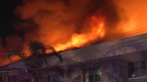 Flames were seen coming from the building's roof. (9NEWS)