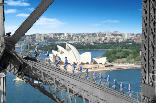 Four million people from 140 countries have donned blue jumpsuits with BridgeClimb in 20 years. Picture: BridgeClimb