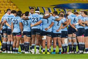 The Waratahs team huddle for a team talk before the Super Rugby Pacific match between the Hurricanes.