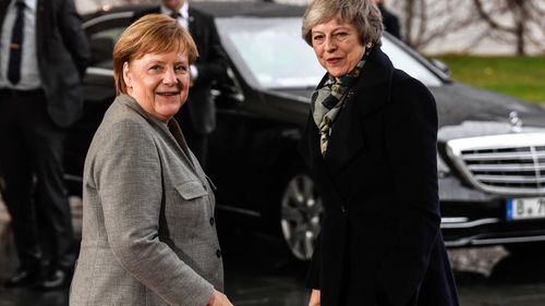 British Prime Minister Theresa May, arrives for a meeting with German Chancellor Angela Merkel, right, in the chancellery in Berlin, Germany.
