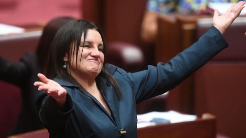 She reacts after delivering a statement on her resignation in the Senate chamber (Image: AAP)