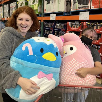 Girls holding Squishmallows at Costco
