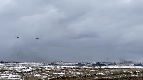 In this photo taken from video and released by the Russian Defense Ministry Press Service on Wednesday, Feb. 2, 2022, Russian and Belarusian tanks and military helicopters attend a joint military drills at Brestsky firing range, Belarus.  