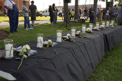 Candles and flowers are laid out in tribute to the 10 victims at a vigil. Picture: AP