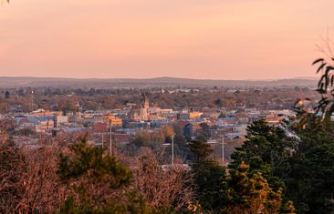 Ballarat, Victoria, Australia - May, 23 2021: Brilliant pinks in the sky above the regional Victorian mining city of Ballarat as the sunsets off in the distance as seen from Black Hill lookout.