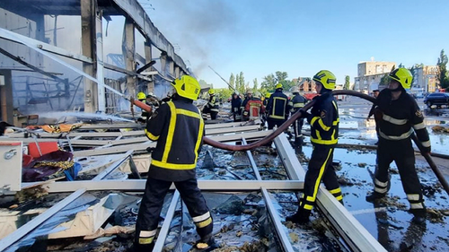 Firefighters work to extinguish a fire at a shopping center burned after a rocket attack in Kremenchuk, Ukraine, Monday, June 27, 2022. (Ukrainian State Emergency Service via AP)