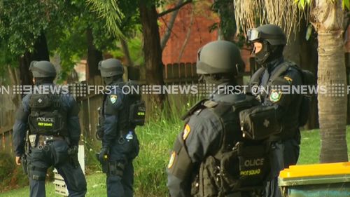 Police at the home in Wentworthville, where two people were arrested. (9NEWS)