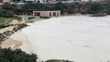 Foamy waves overwhelm the sand at Tamarama Beach.