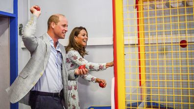 Britain's Prince William and Kate, the Duchess of Cambridge play a game at an amusement arcade, where TV program Gavin and Stacey was filmed, in Barry Island, Wales, Wednesday Aug. 5, 2020, during their visit to speak to local business owners about the impact of COVID-19.