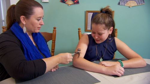 Even a feather on her arm feels like a knife.