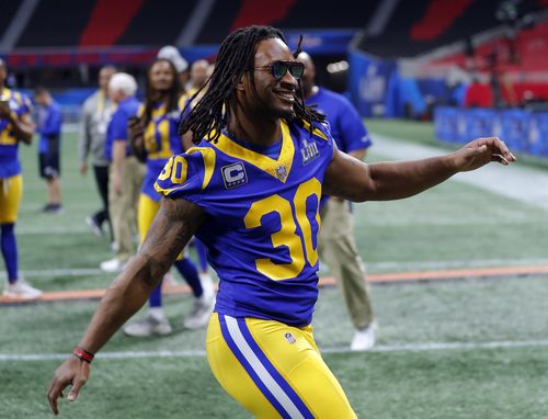 Los Angeles Rams running back Todd Gurley (30) rushes to join teammates for a photograph during walkthrough at the Mercedes Benz Stadium for the NFL Super Bowl 53.