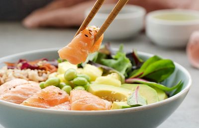 Healthy salmon poke bowl with avocado