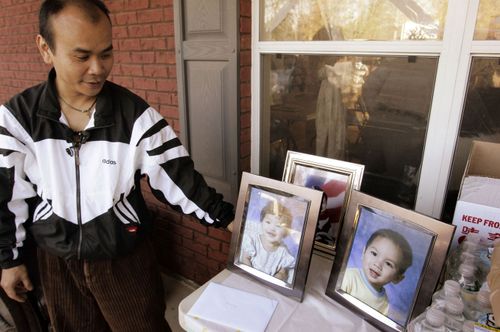 Family spokeperson Kam Phengsisomboun with iomages of the chuldren who were thrwon from the bridge by their father Luong, whose death sentence has been reduced to life in prison.