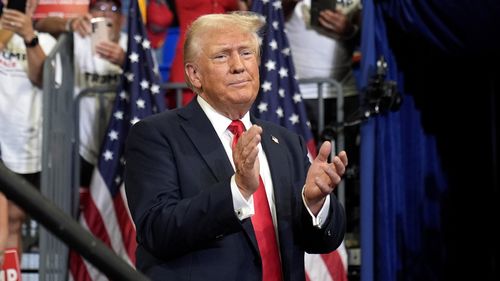 Republican presidential candidate former President Donald Trump claps at a campaign rally at Georgia State University in Atlanta, Saturday, Aug. 3, 2024. (AP Photo/John Bazemore)