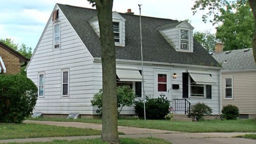 The windows of the home were either boarded or covered up.