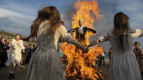 Demonstrators dance around a burning effigy of the Russian President Vladimir Putin during an anti-war action in Tbilisi, Georgia. 