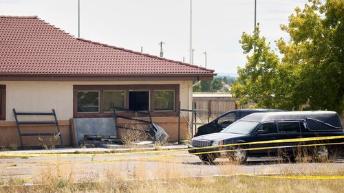 A hearse and van sit outside the Return to Nature Funeral Home in Penrose, Colo., on Oct. 6, 2023. (AP Photo/David Zalubowski, File)