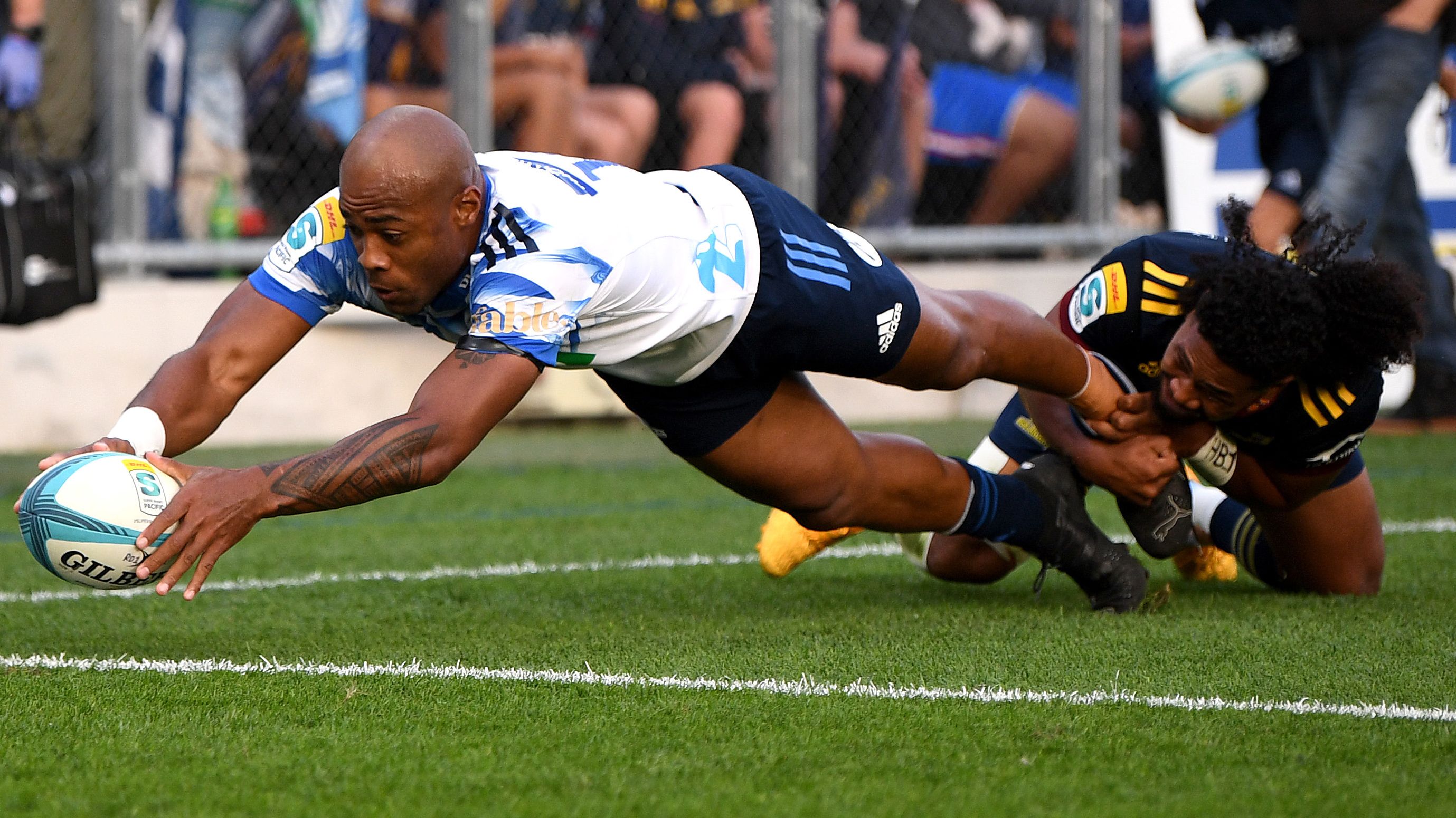 Mark Telea of the Blues scores the opening try.