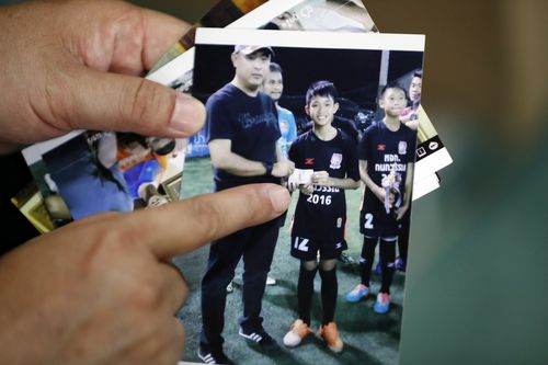 Mr Konkum shows a picture of his son in a recent photograph he took. Picture: AAP