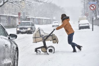 Slovakia: A woman pushes a pram through the snow