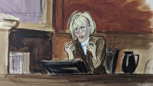 In this courtroom sketch, E. Jean Carroll testifies on the witness stand .