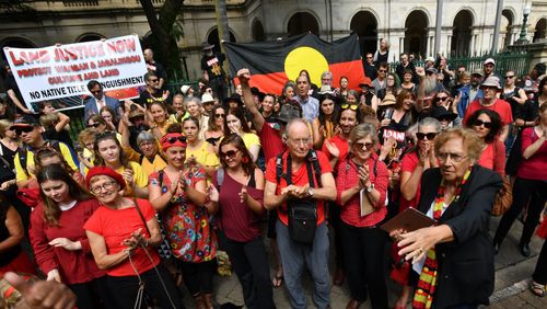 Wangan and Jagalingou traditional owners and their supporters are seen protesting outside Parliament House in Brisbane in March 2018. Picture: AAP