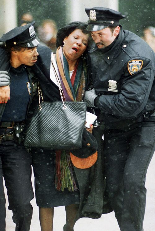 In this Feb. 26, 1993 file photo, two New York City police officers help an injured women away from the scene of the World Trade Center truck bomb attack. It was a terror attack that foreshadowed Sept. 11: the deadly World Trade Center bombing that happened 25 years ago Monday. (AP Photo/Joe Tabacca, File)