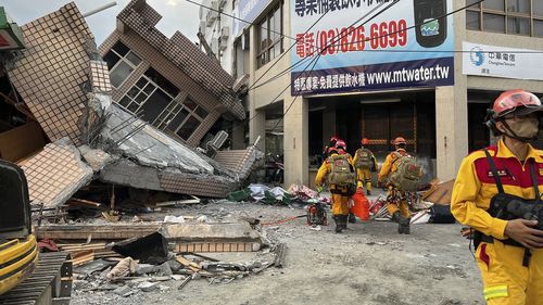 Firefighters in the search for trapped victims in a collapsed residential building following earthquake in Yuli township in Hualien County, eastern Taiwan, Sunday, Sept. 18, 2022. (Hualien County Fire Department via AP)