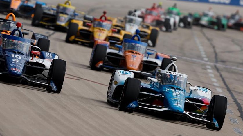 Josef Newgarden leads a pack of cars running side-by-side at Texas Motor Speedway.