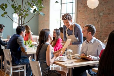 Waitress serving table.