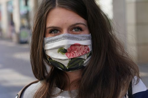 A young woman wearing a home-made protective face in Germany.