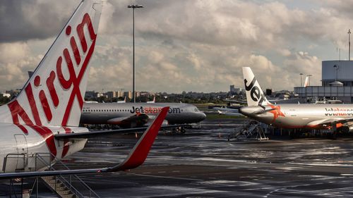 Virgin and Jetstar aircraft sit at Sydney airport.