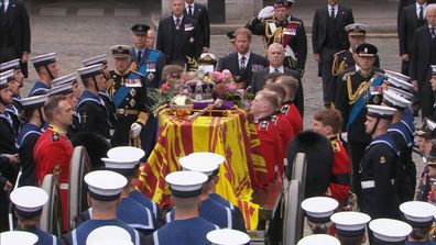 King Charles III, Prince William, Prince Harry and Prince Andrew stand behind the Queen's coffin before it leaves Westminster Hall.