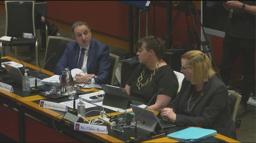 Deputy secretary Murat Dizdar (left) during an estimates hearing.