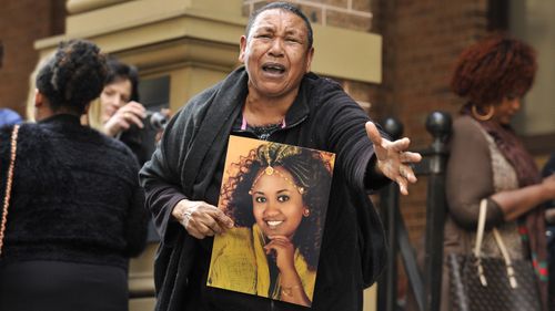 Ethiopian woman Wubanchi Asfaw, pictured in a photo held by her mother, was stabbed to death by her husband in Sydney in 2014.