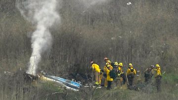 Firefighters and sheriffs work the scene of a helicopter crash that killed former NBA basketball player Kobe Bryant
