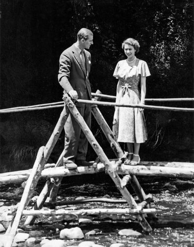Princess Elizabeth and the Duke of Edinburgh on a bridge in the grounds of Sagana Lodge, their wedding present from the people of Kenya, 5th February 1952. The following day, news would arrive of the death of King George VI and Elizabeth's accession to the throne. (Photo by NCJ Archive/Mirrorpix/Mirrorpix via Getty Images)
