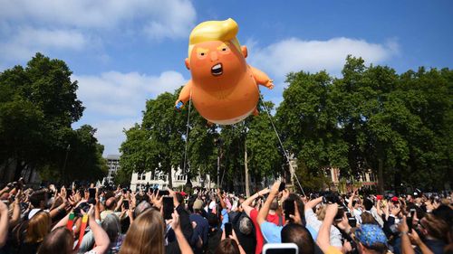 The Trump balloon rising above Parliament Square. (AAP)