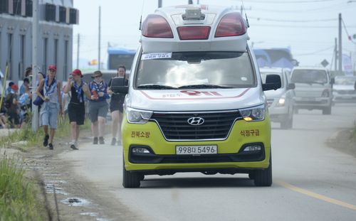 An ambulance drives to a hospital from a scout camping site during the World Scout Jamboree in Buan, South Korea, Friday, Aug. 4, 2023.  